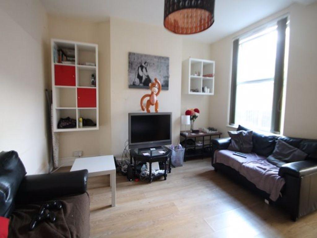 A cozy living room featuring two large windows ...