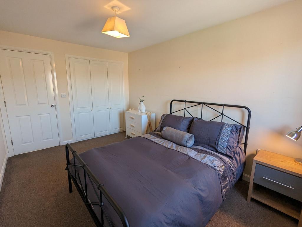 A cozy double bedroom featuring a comfortable m...