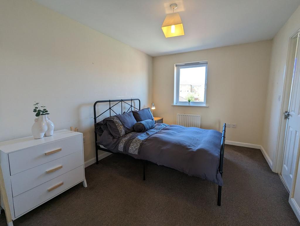 Bright and tidy double bedroom featuring a styl...