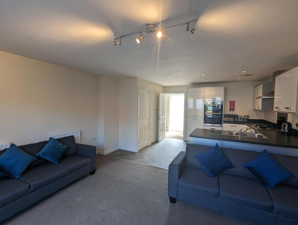 A modern and tidy open-plan living room with tw...