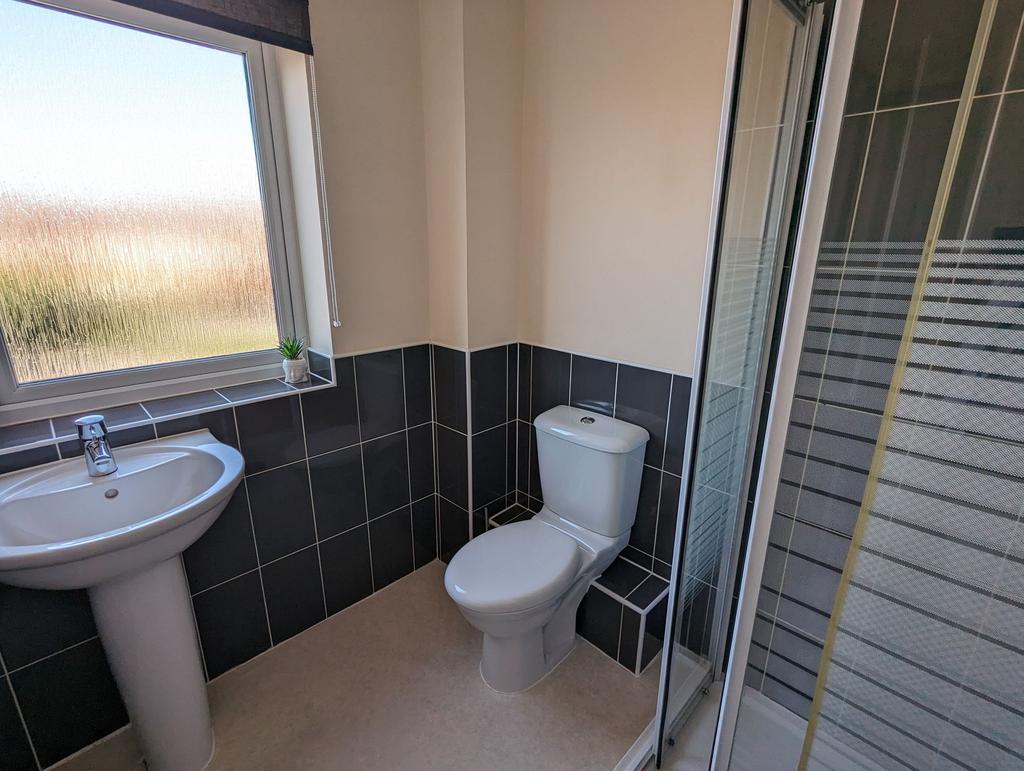 A clean and modern bathroom featuring a white p...