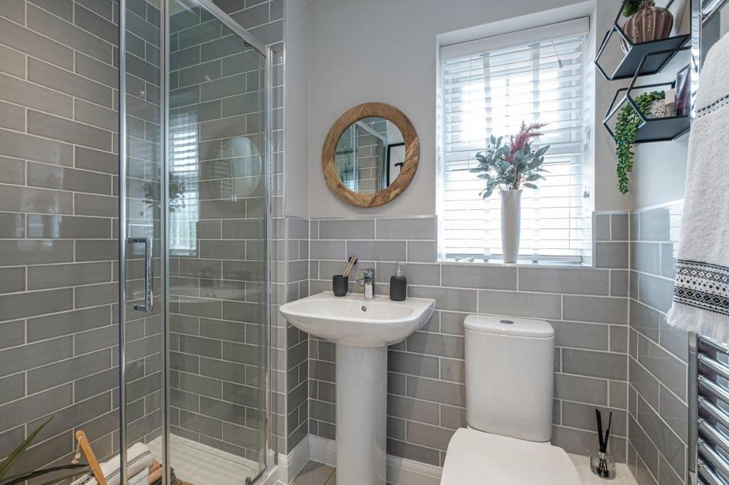Photo of a tiled bathroom with a bath, sink,...