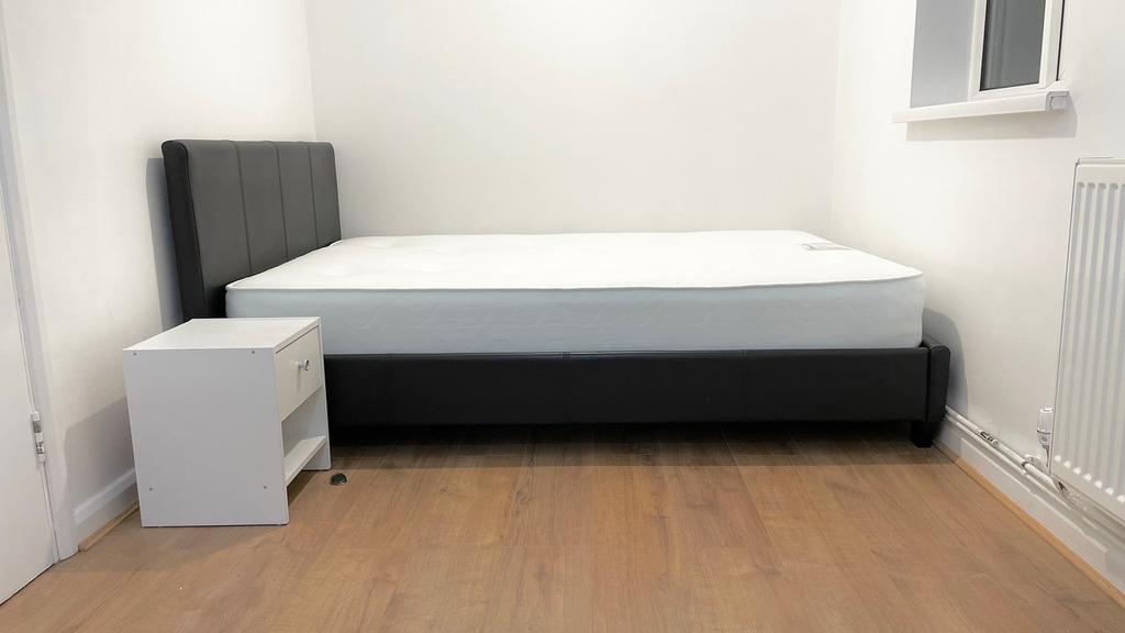 This inviting double bedroom features a modern ...