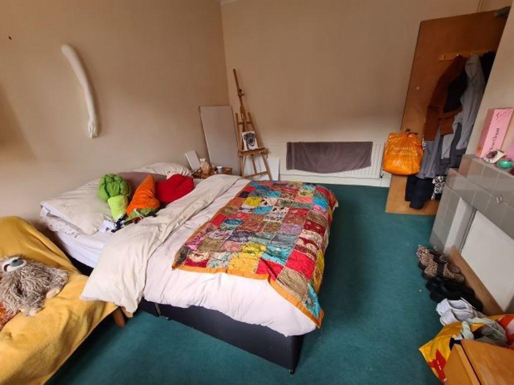 A cozy double bedroom featuring a colorful patc...