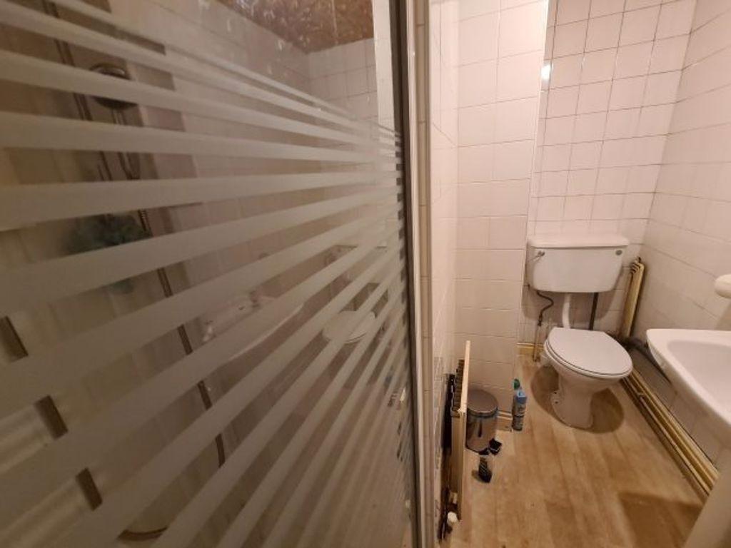 A neat and functional bathroom featuring a walk...