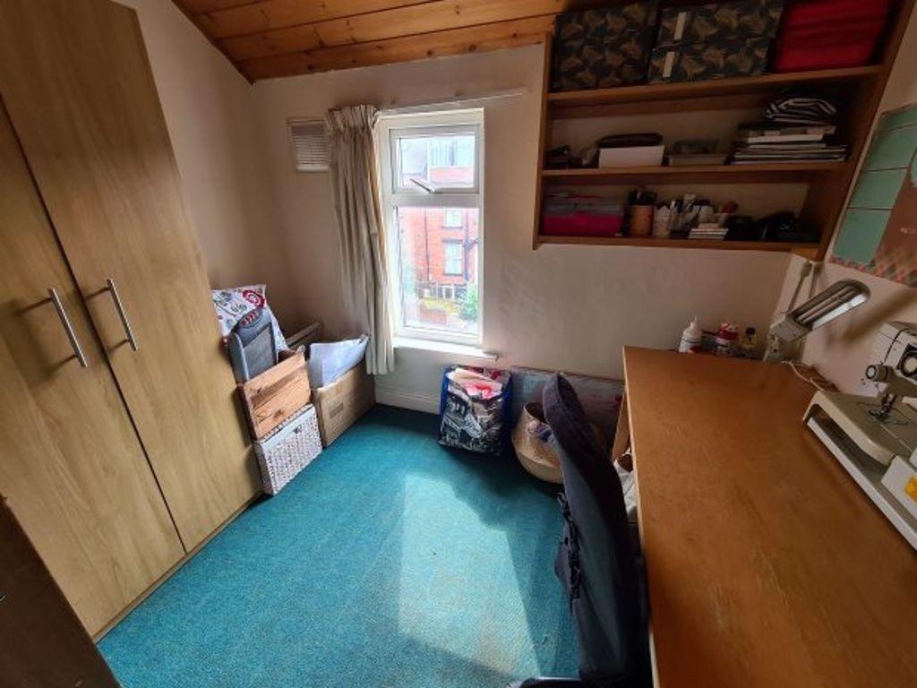 A cozy single bedroom featuring a large wooden ...