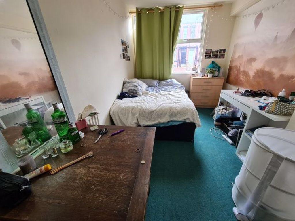 Cozy bedroom with a comfortable single bed, a d...