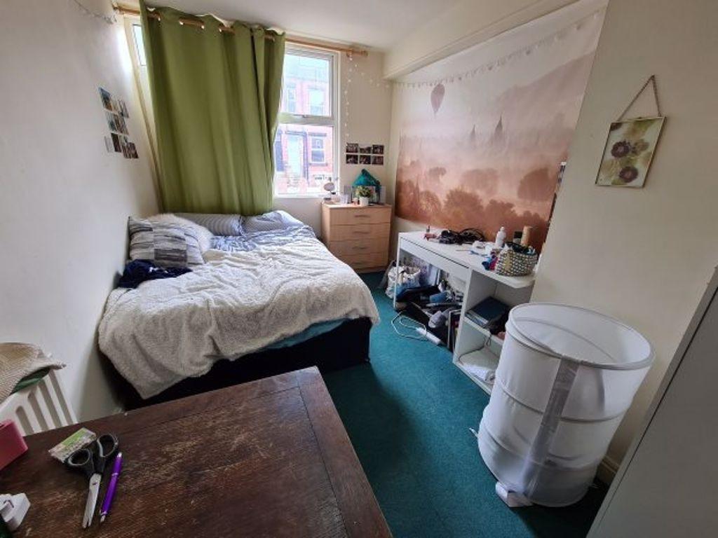 A cozy single bedroom featuring a comfortable b...