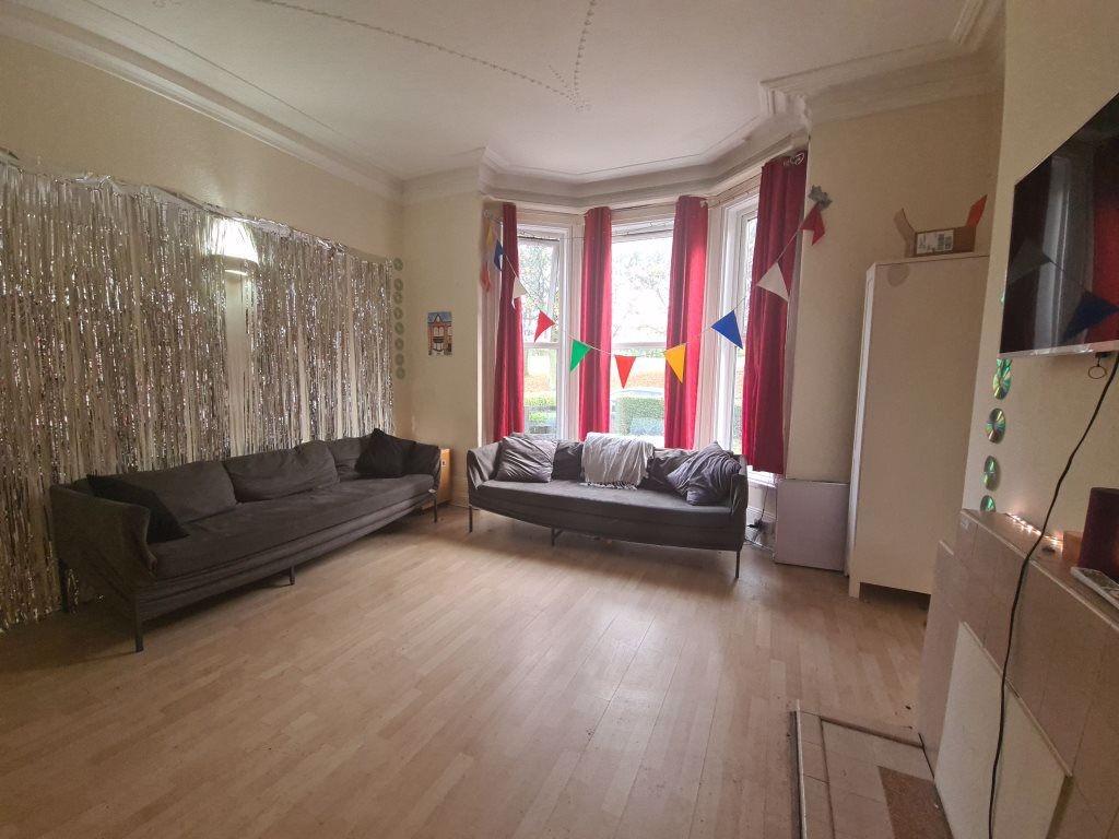 Bright and spacious living room featuring large...