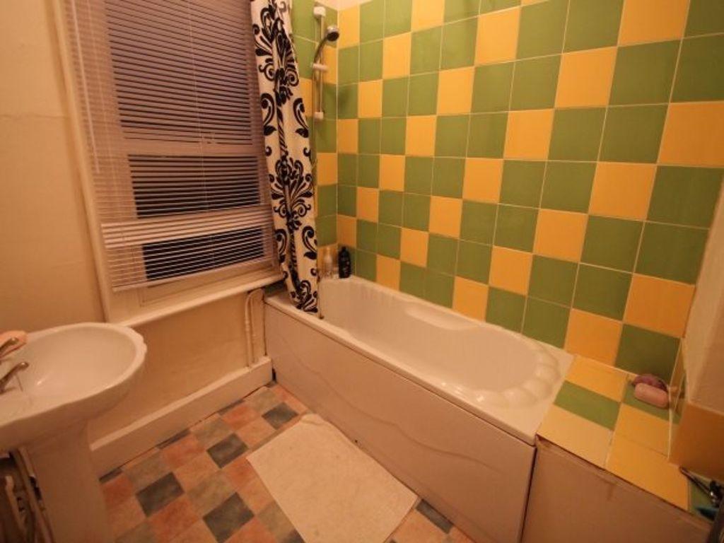 A colorful bathroom featuring a bathtub with a ...