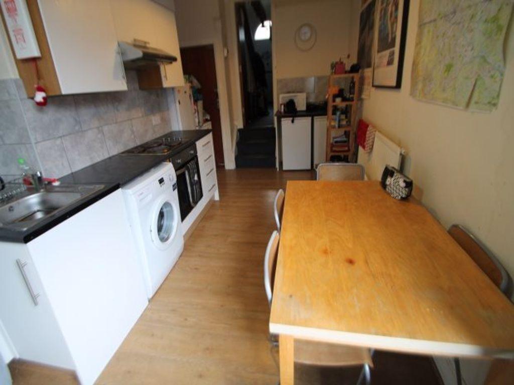 A functional kitchen space featuring a long woo...