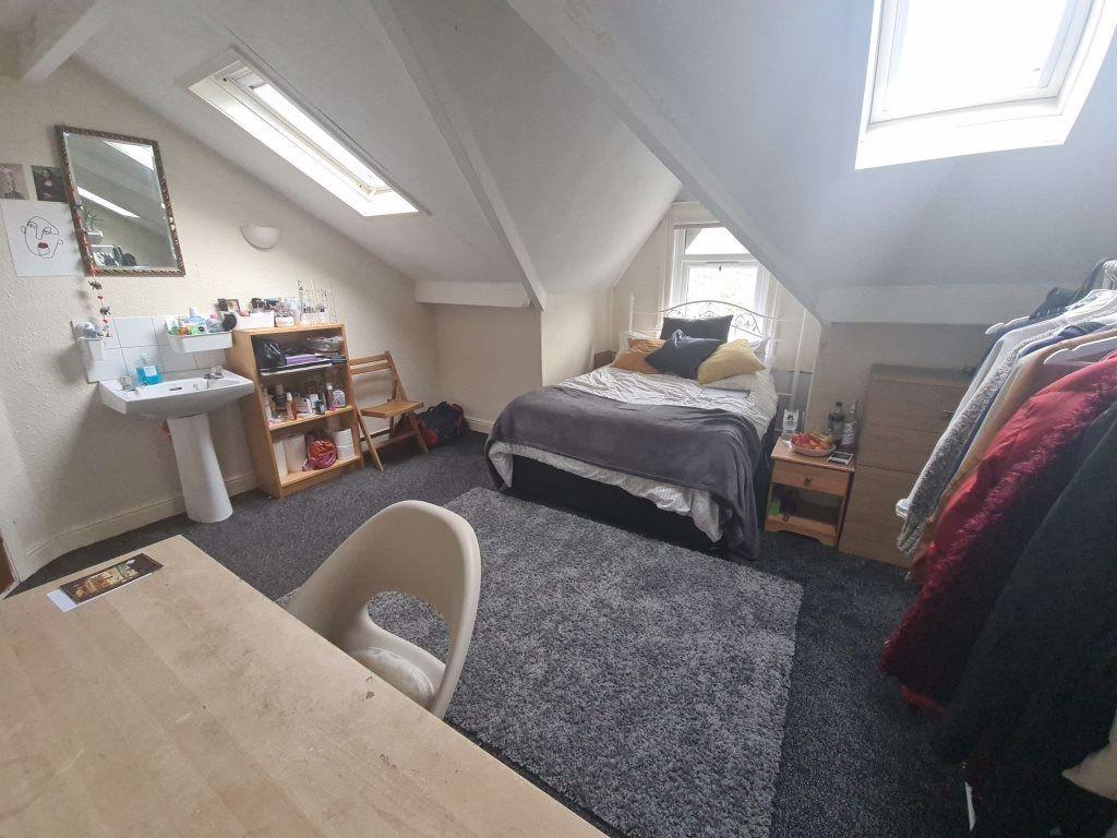 A cozy and bright single bedroom featuring a co...