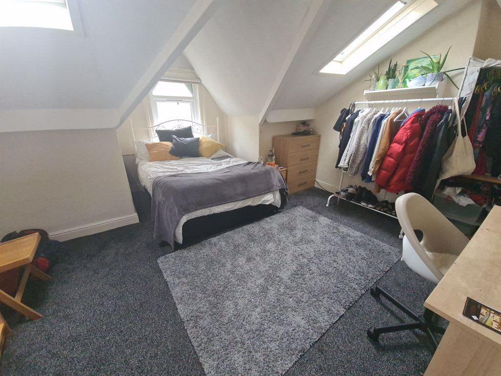 A cozy single bedroom with a comfortable bed tu...