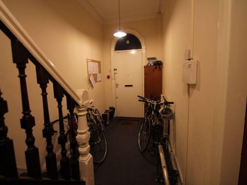 A narrow hallway featuring classic wooden banis...