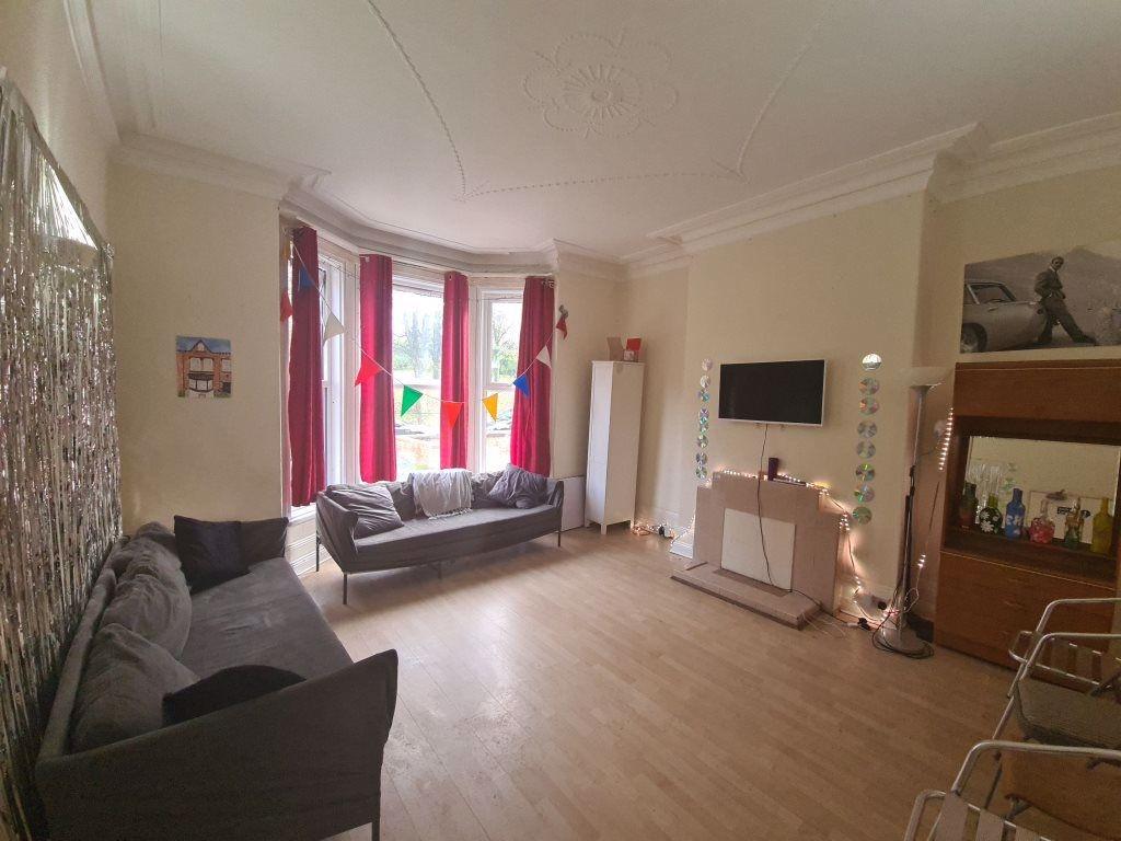 A bright and inviting living room with a bay wi...