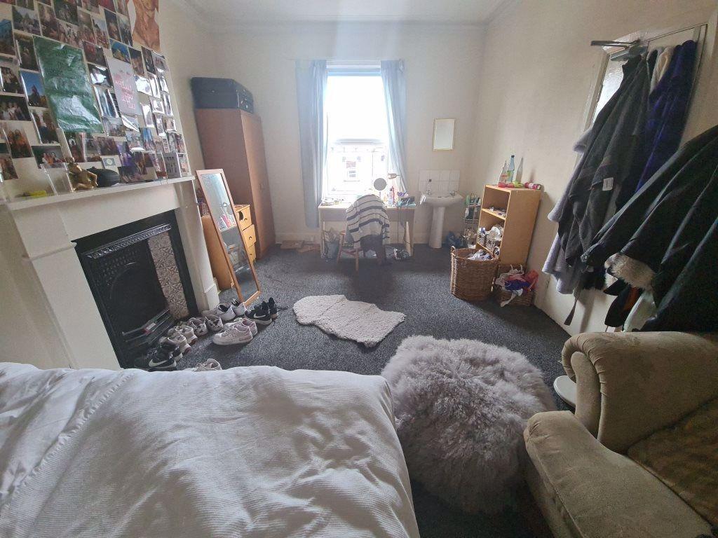 A cozy and inviting master bedroom featuring a ...