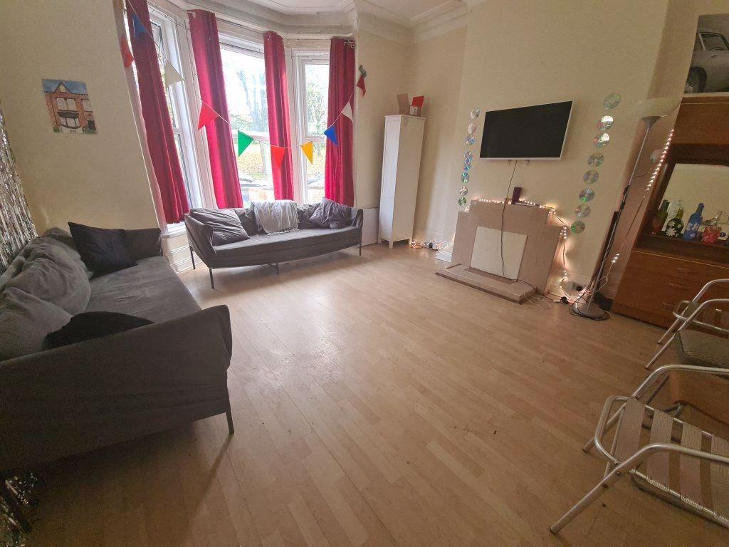 A bright and welcoming living room featuring la...