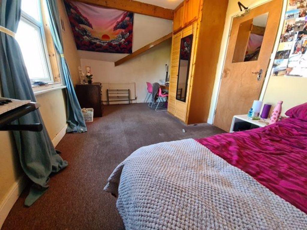 A cozy double bedroom featuring a comfortable b...