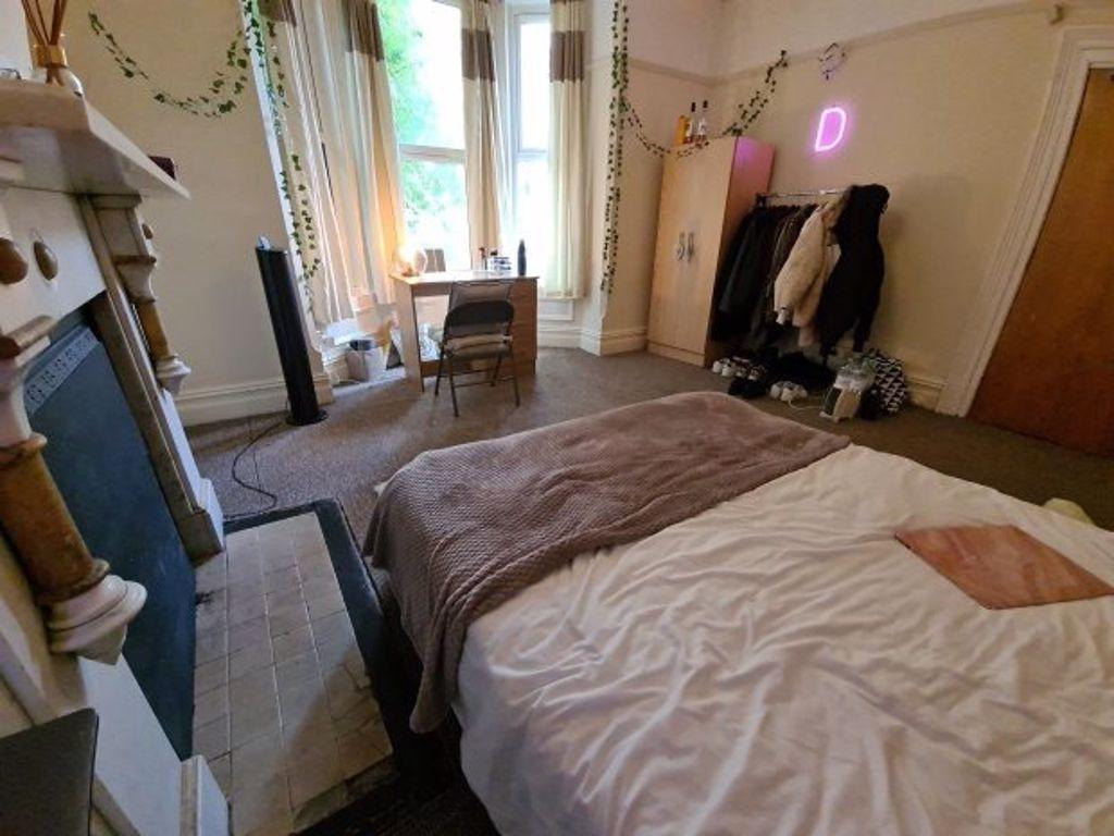 A spacious and well-lit master bedroom featurin...