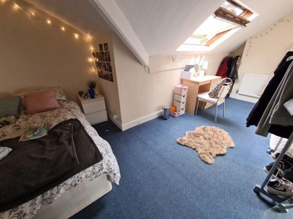 A cozy bedroom featuring a double bed, with a w...