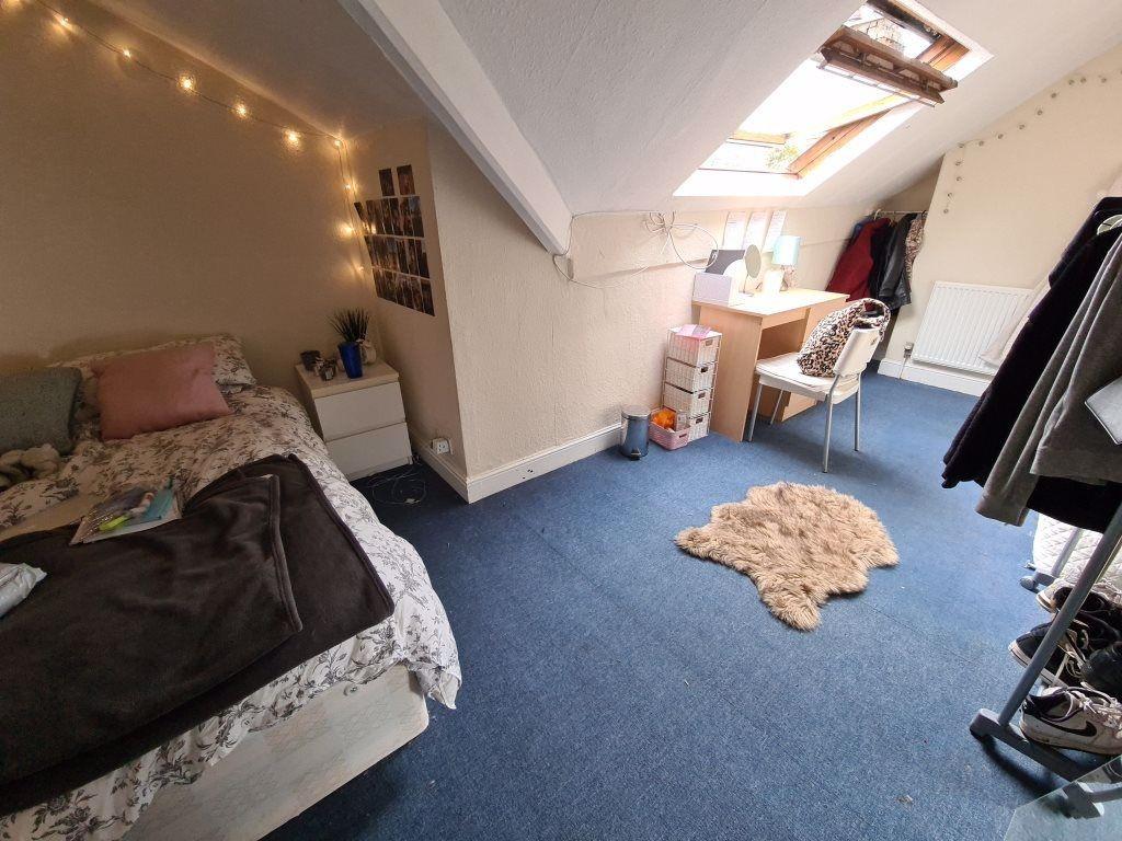 A cozy bedroom with a bed, some furniture, and ...