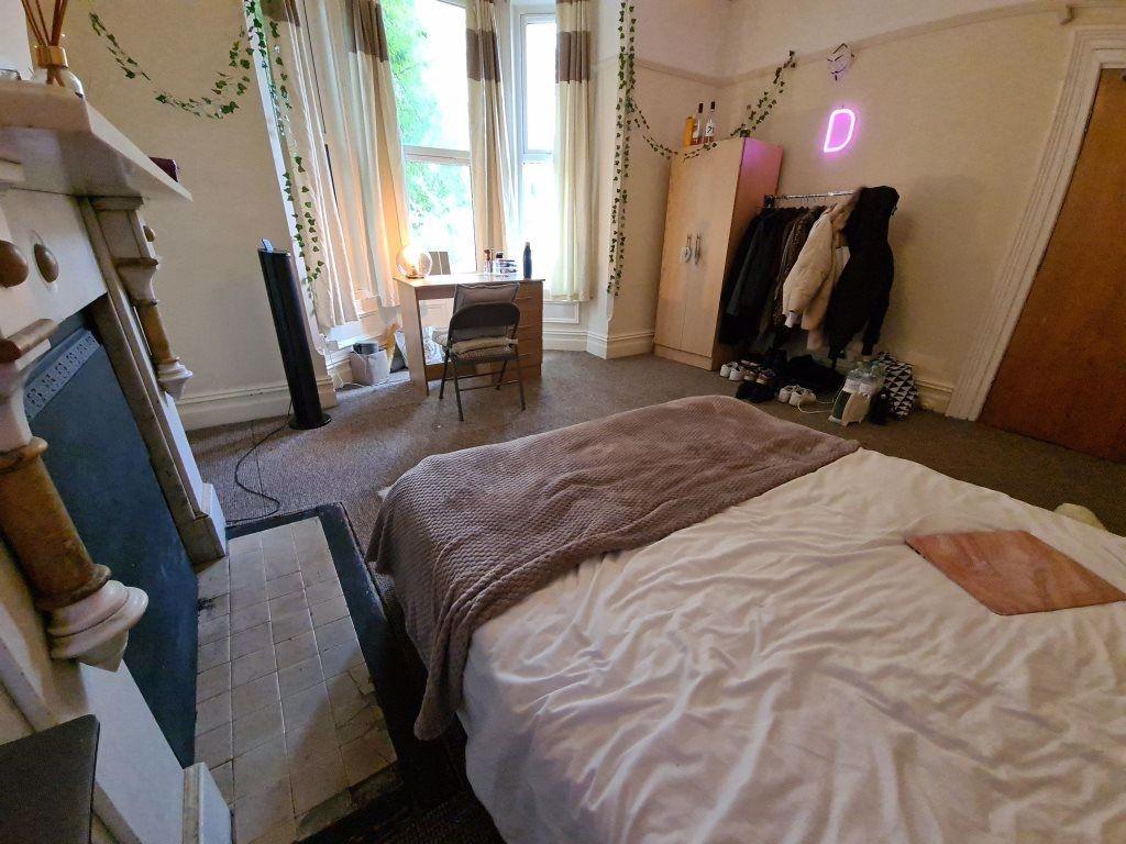 A spacious and inviting master bedroom featurin...