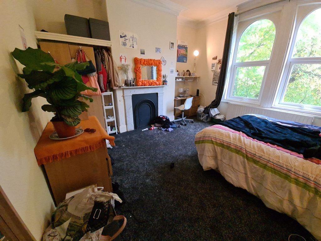 A cozy bedroom with a large window providing na...