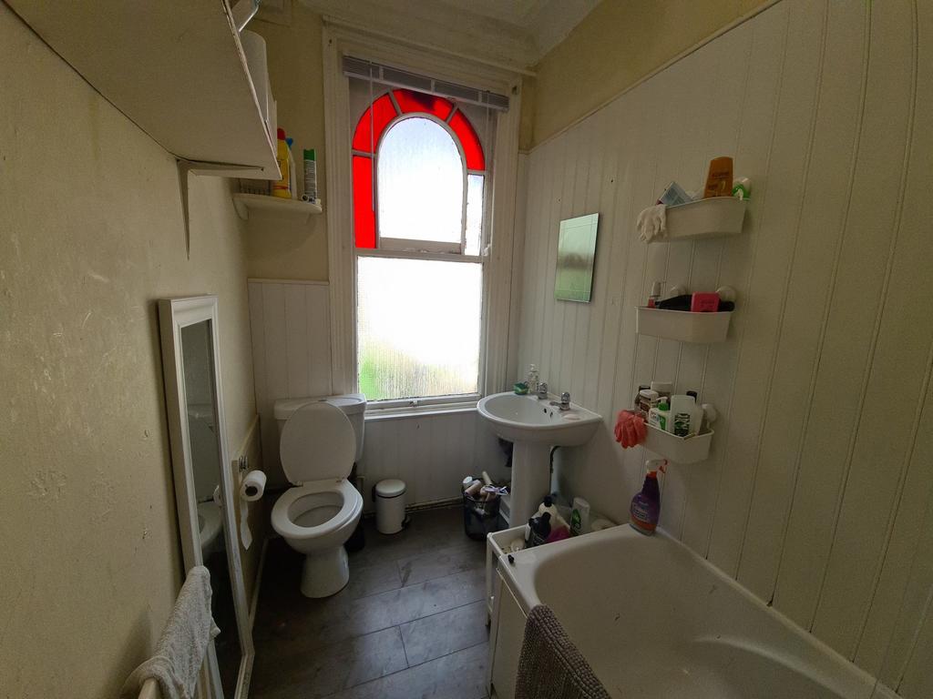 A well-maintained bathroom featuring a bathtub,...