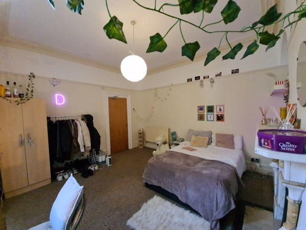 A cozy and well-maintained bedroom featuring a ...