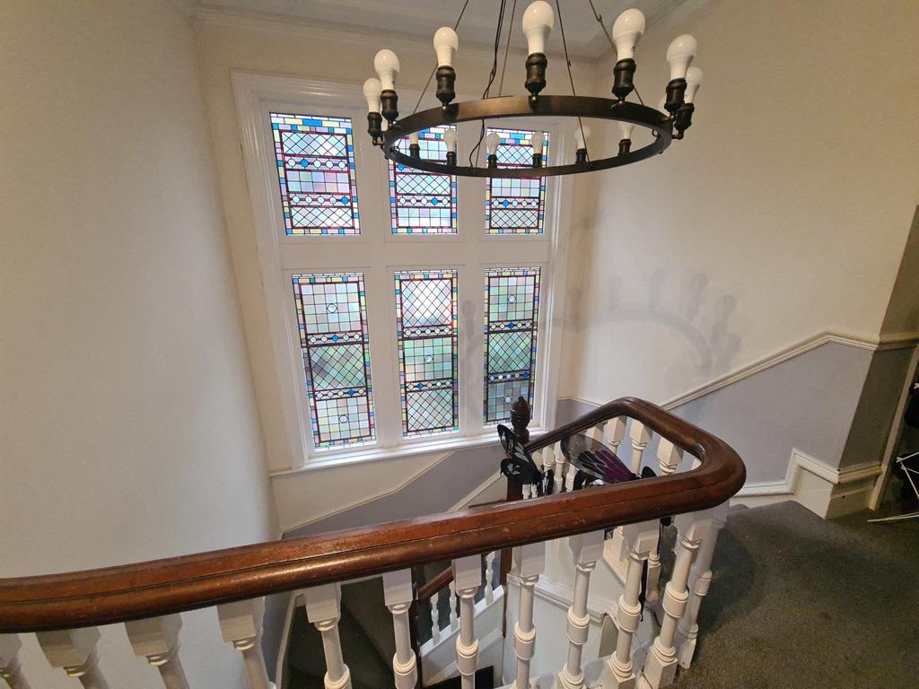 A charming staircase with a classic wooden hand...