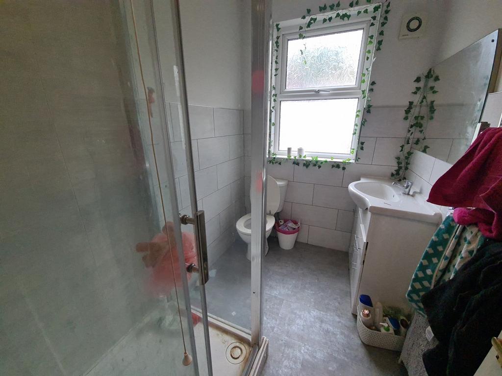A clean and functional bathroom featuring a sho...