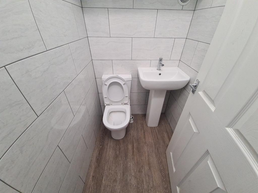 Bright and clean small toilet room featuring mo...