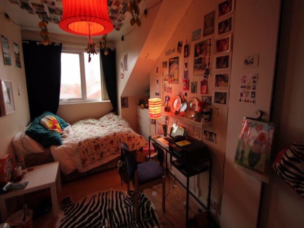 Cozy single bedroom featuring a comfortable bed...