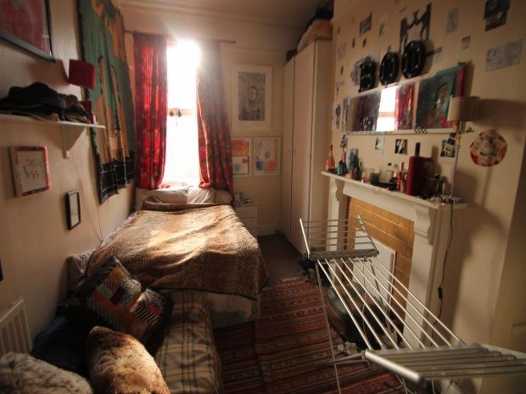 Cozy single bedroom with a warm and inviting at...