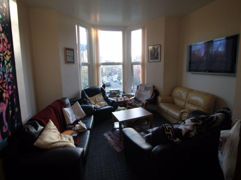 A cozy and inviting living room featuring a lar...