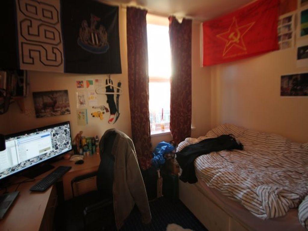 Cozy single bedroom featuring a comfortable bed...
