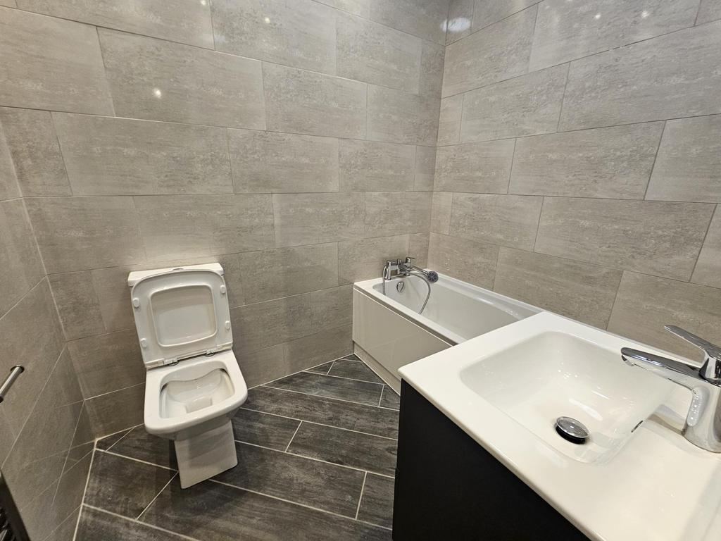 Modern bathroom suite featuring a clean and sle...