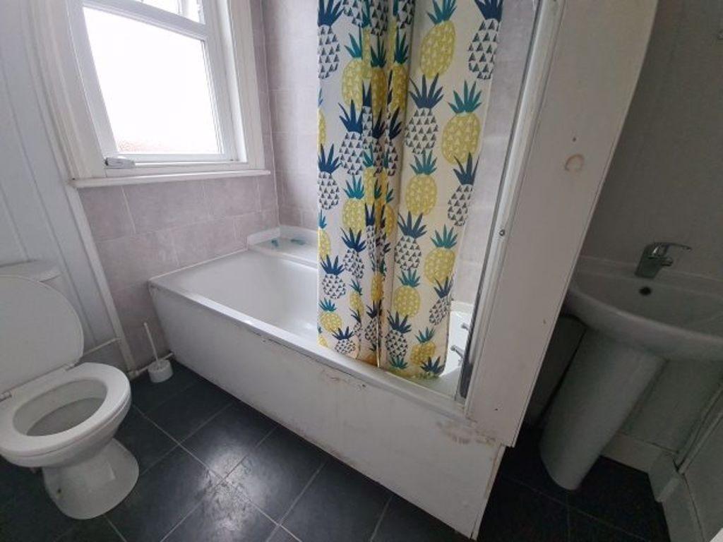 Bright bathroom with a full-size bath and showe...