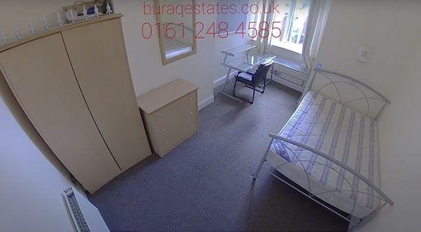 A neat and tidy single bedroom featuring a whit...