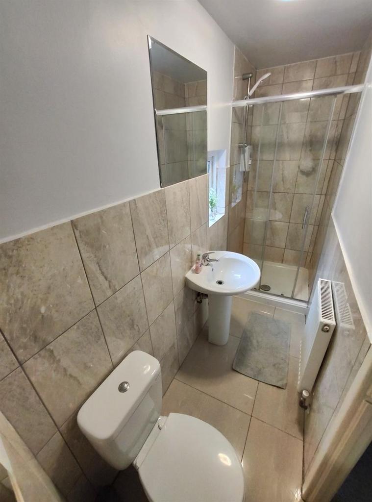 A clean and modern bathroom featuring beige til...