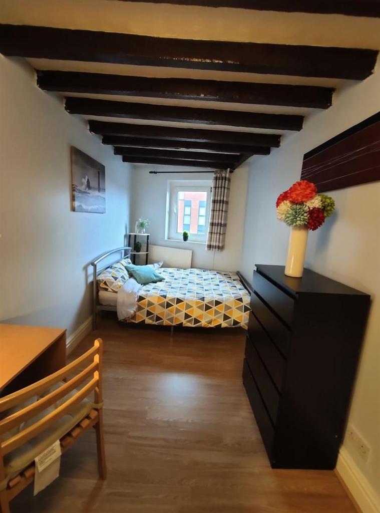 A cozy single bedroom featuring wooden ceiling ...