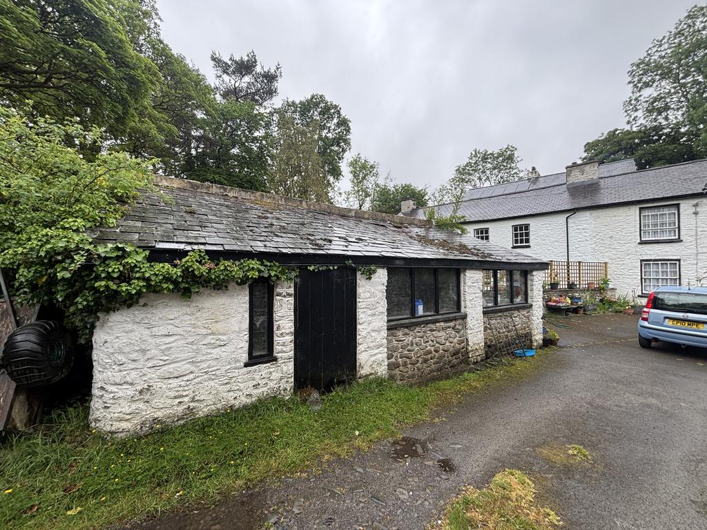 Open fronted stone and slate garage