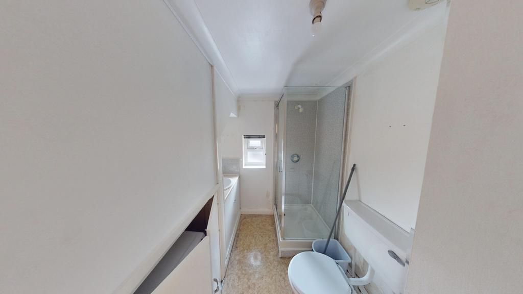 A tidy bathroom featuring a modern shower and a...