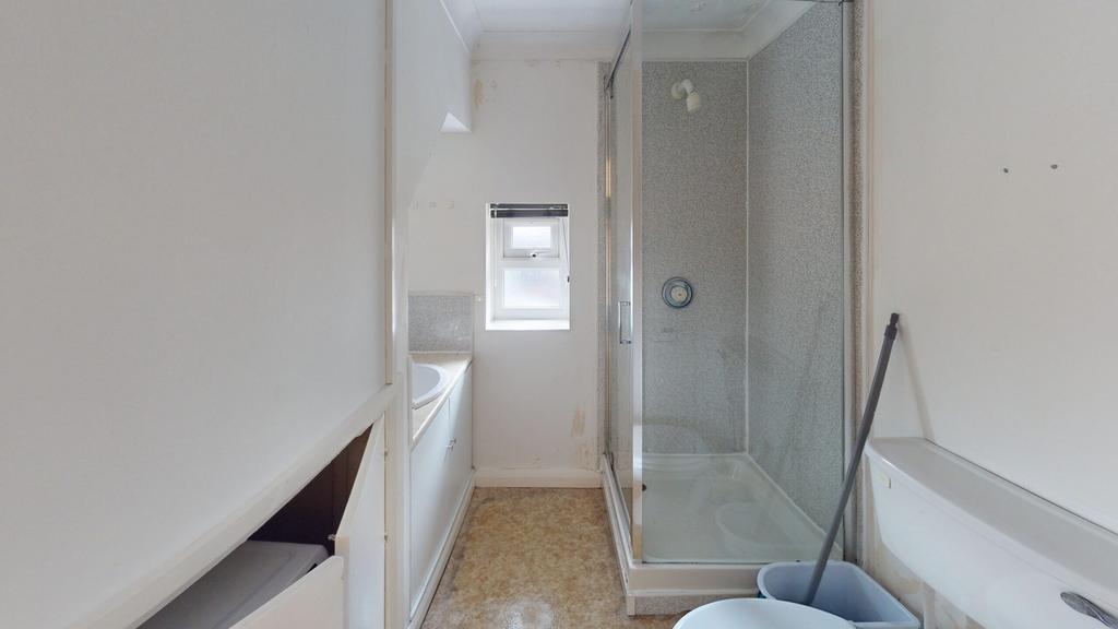 A tidy bathroom featuring both a bath and a sho...