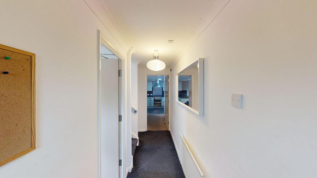 A tidy hallway with ample natural light and a w...