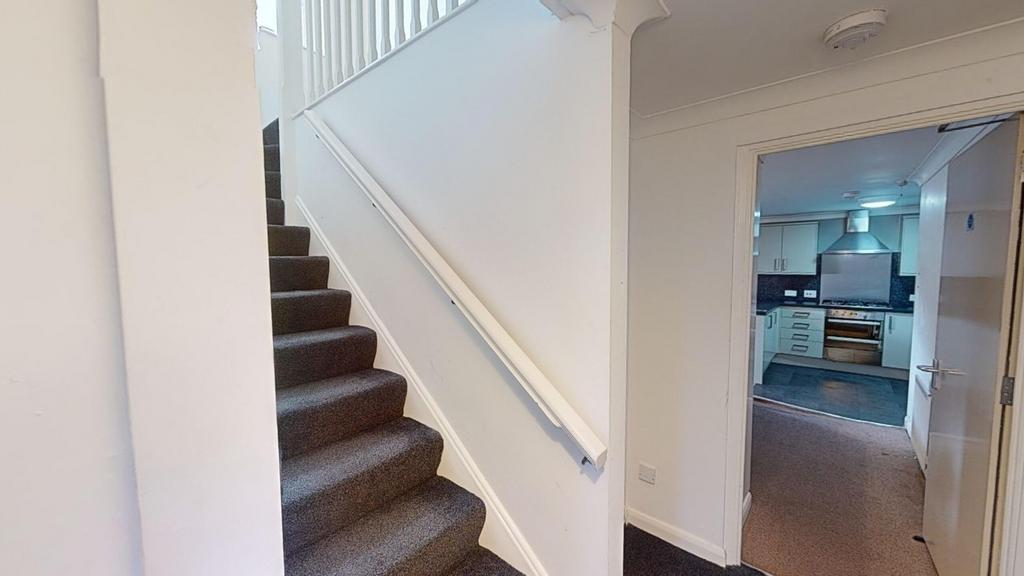 A well-maintained staircase leading to the uppe...