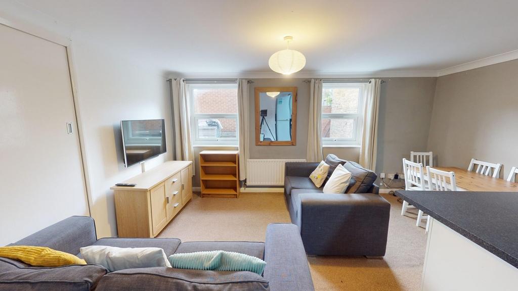 A spacious and inviting modern living room, per...