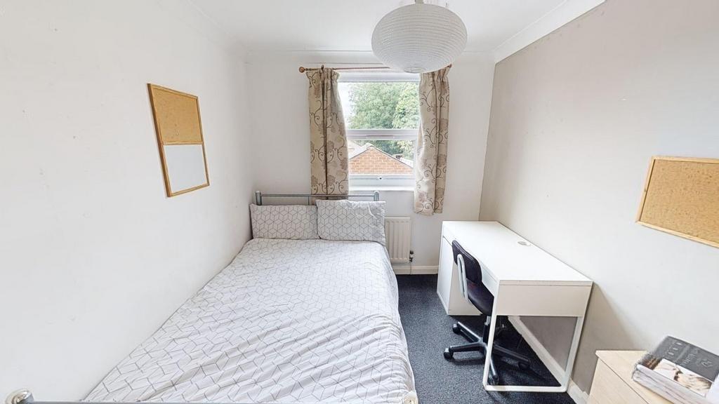 A bright and tidy double bedroom featuring a co...