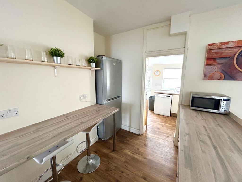 This modern kitchen features sleek countertops,...