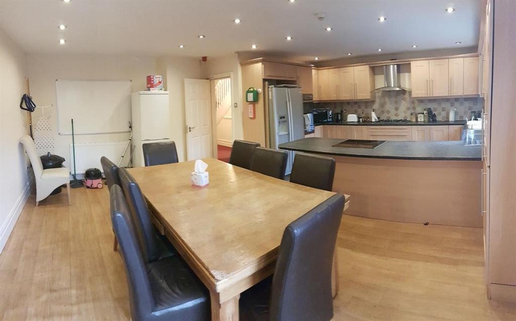 A bright, spacious living area featuring a wood...